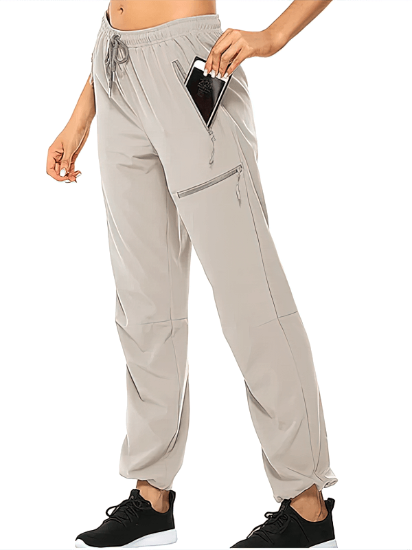 Women's waterproof quick-drying hiking pants with pockets, shown with phone for scale. Perfect for outdoor activities. SF1213